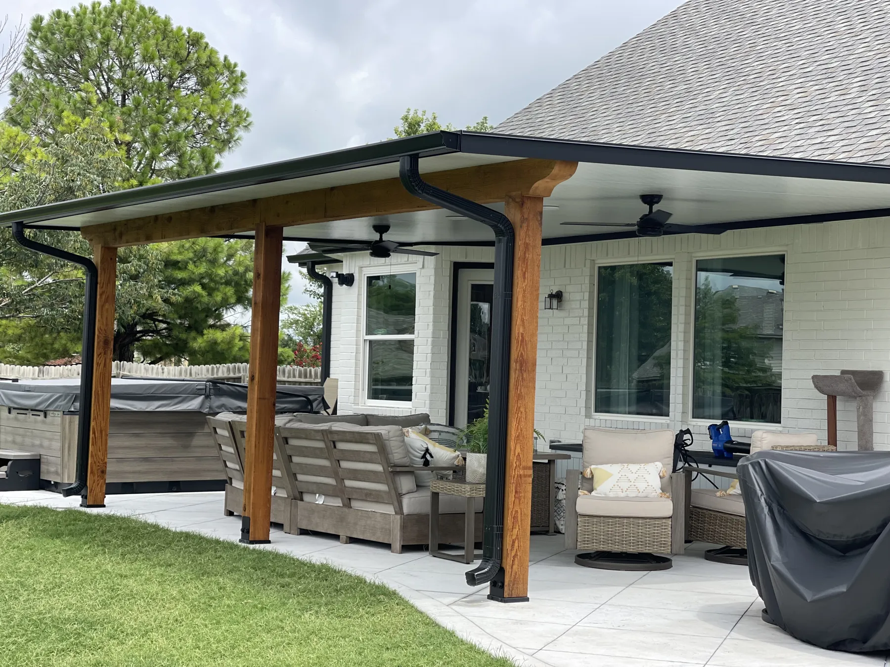 Insulated patio cover with cedar beams and ceiling fans